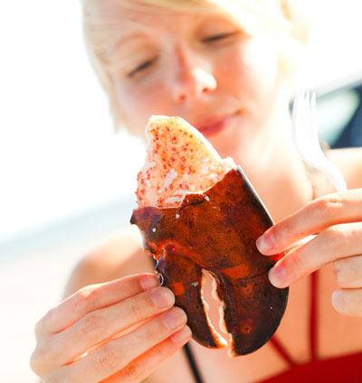 Young woman with cooked Crab