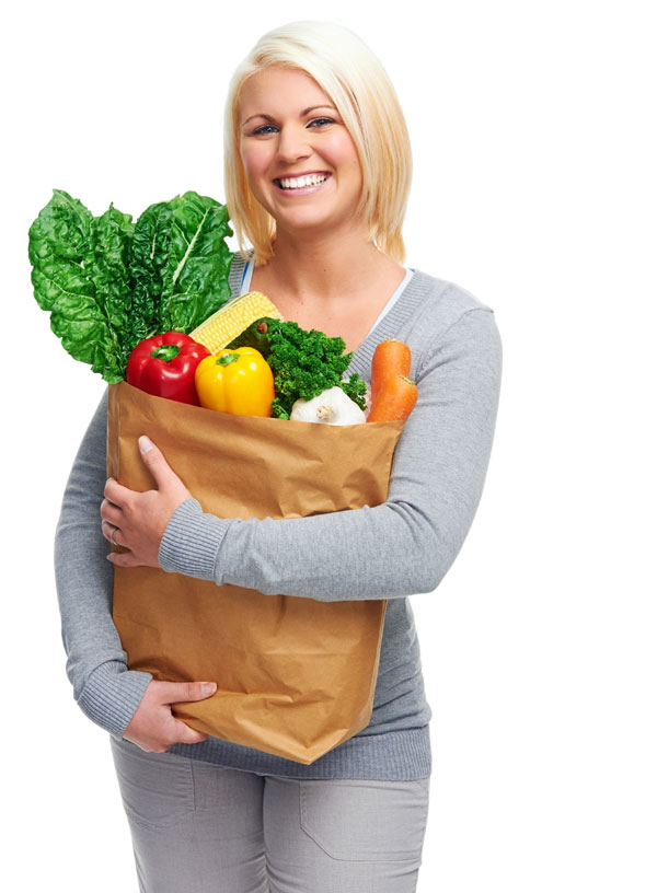 Young woman with spinach in bag