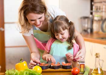 Mother and Daughter cooking Salmon