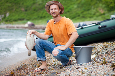 Young man caught lounder fishing on sand