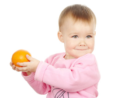 Very young kid with mandarin