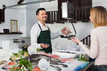 Customer shopping in fish shop