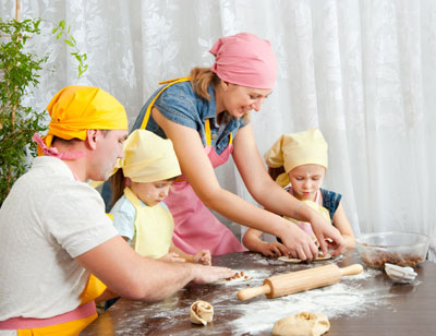 Family making treats with doe and raisins
