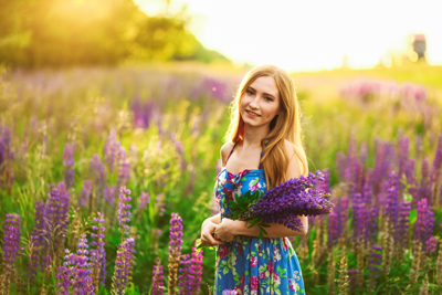 Young lady in field of lupins