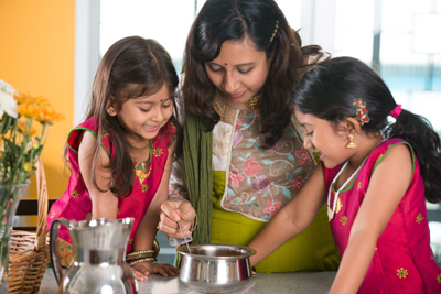 Indian mother cooking for daughter
