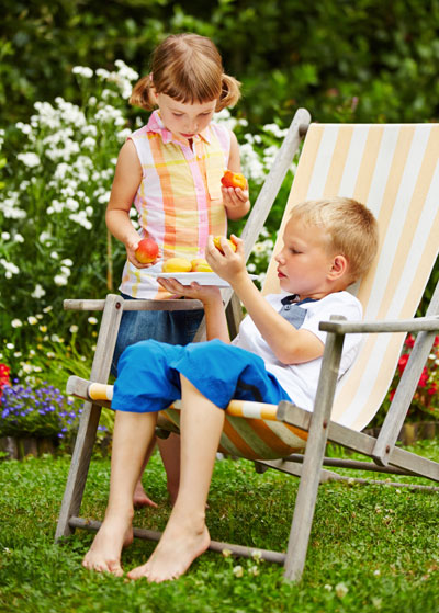 Kids eating nectarine fruits outdoors