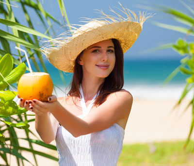 Beautiful woman with coconut cocktail