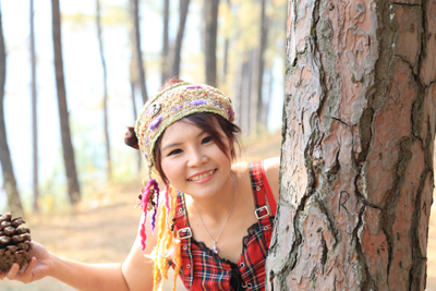 young woman with pine nut outdoors
