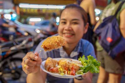 Asian Woman enjoying mixed Seafood