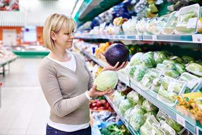 Young Woman looking at Cabbages